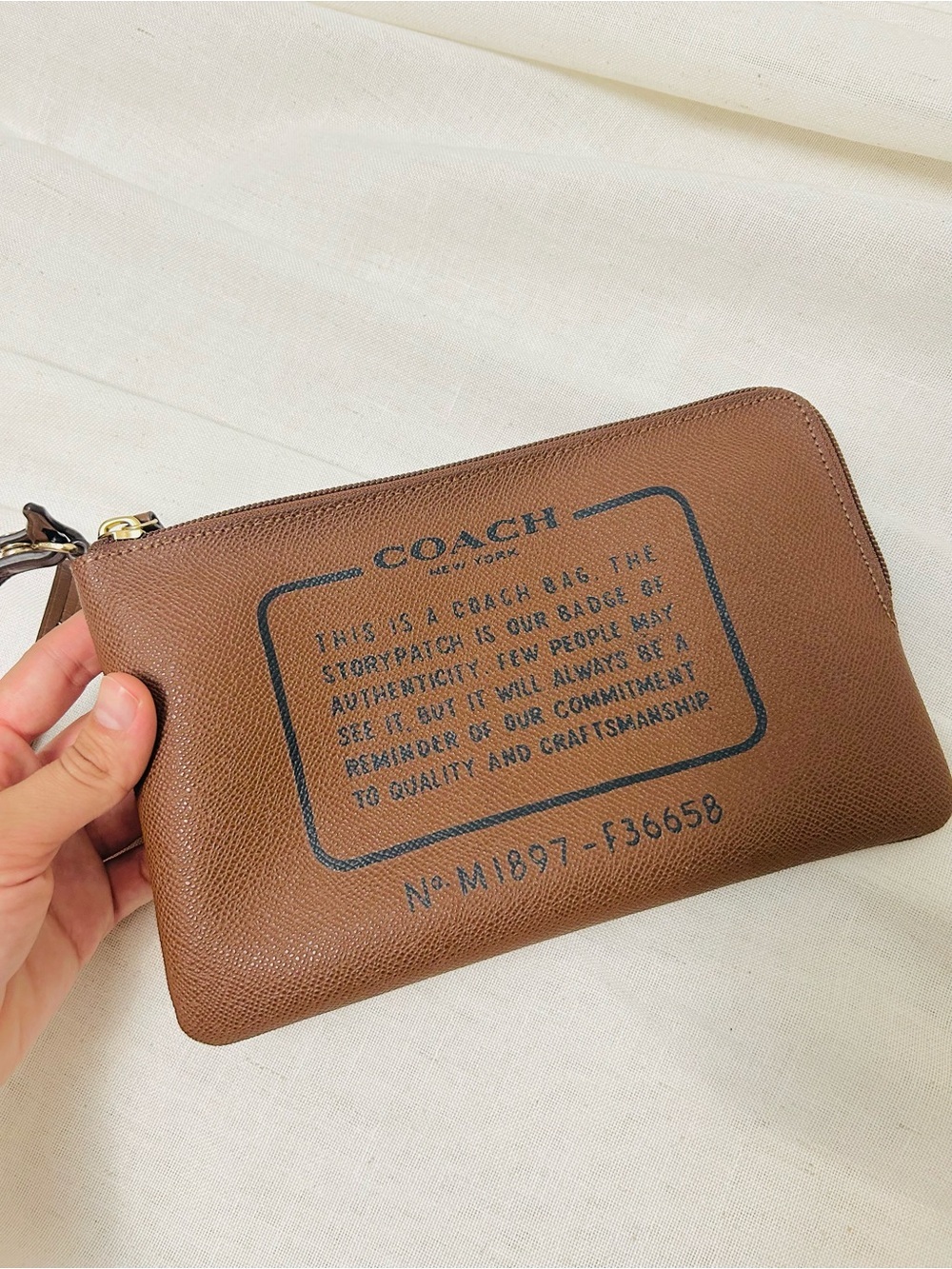 Coach Storypatch Badge tan brown leather wristlet